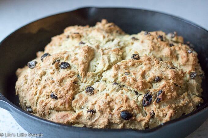 This Irish Soda Bread recipe has raisins (or currants) and optional caraway seeds; this round quick bread easy to make in your cast iron skillet, baked in the oven. Enjoy it for St. Patrick's Day or any time of the year. #sodabread #Irishsodabread #raisins #American #recipe #bread #quickbread #carawayseeds #StPatricksDay
