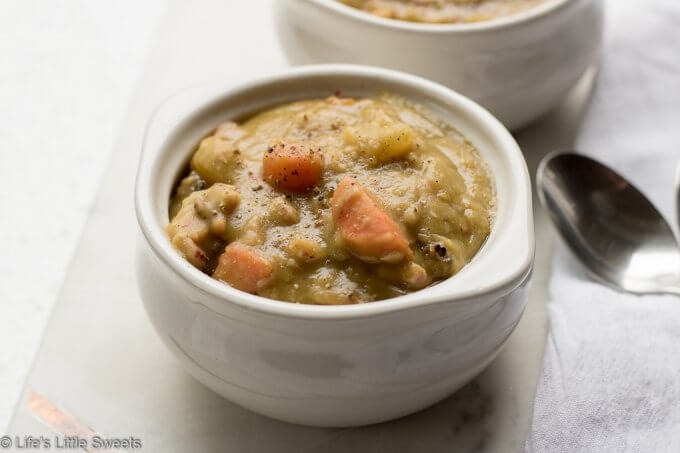 Split Pea Soup is hearty soup filled with protein, veggies and carbs, perfect for sustaining you during cold weather. Enjoy this classic, family soup recipe which is a meal in an of itself! #splitpeasoup #recipe #carrots #peas #potatoes #ham #savory #bayleaves #marjoram #celery