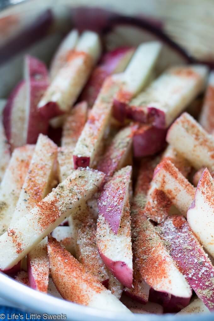 Air Fryer French Fries recipe process photo with raw potatoes with seasonings over them