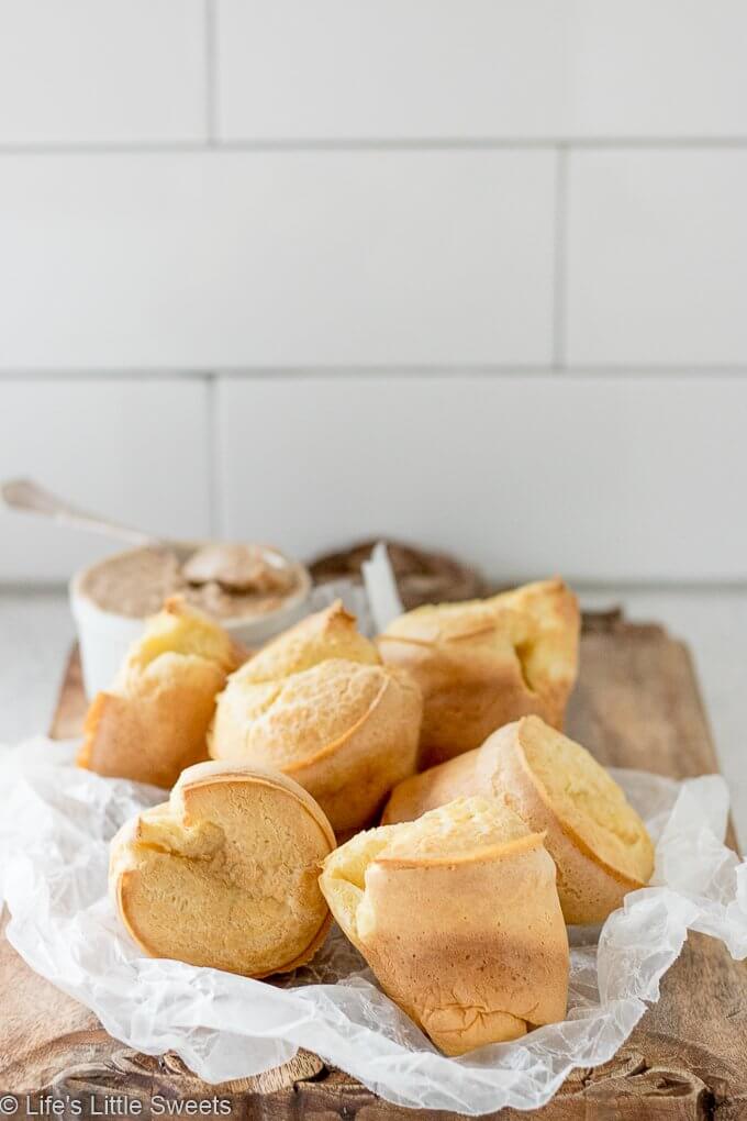 Popovers are an American bread recipe made of an egg and flour-based batter baked in individual molds. Also, known as the “American Yorkshire Pudding,” this recipe dates back to 1850. They can be served any time of the day and are delicious when eaten fresh and topped with Maple Cinnamon Butter. Popovers recipe! #popovers #recipe #homemade #appetizer #bread #eggs