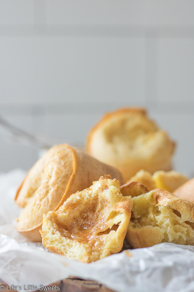 Popovers are an American bread recipe made of an egg and flour-based batter baked in individual molds. Also, known as the “American Yorkshire Pudding,” this recipe dates back to 1850. They can be served any time of the day and are delicious when eaten fresh and topped with Maple Cinnamon Butter. Popovers recipe! #popovers #recipe #homemade #appetizer #bread #eggs