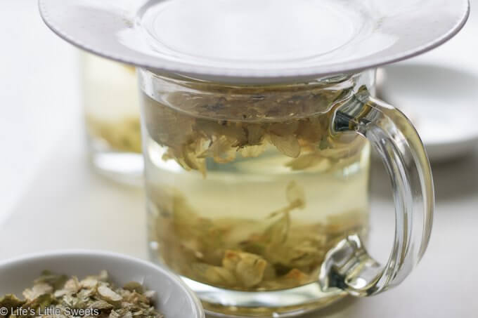 Hops Flower Tea steeping in a clear mug