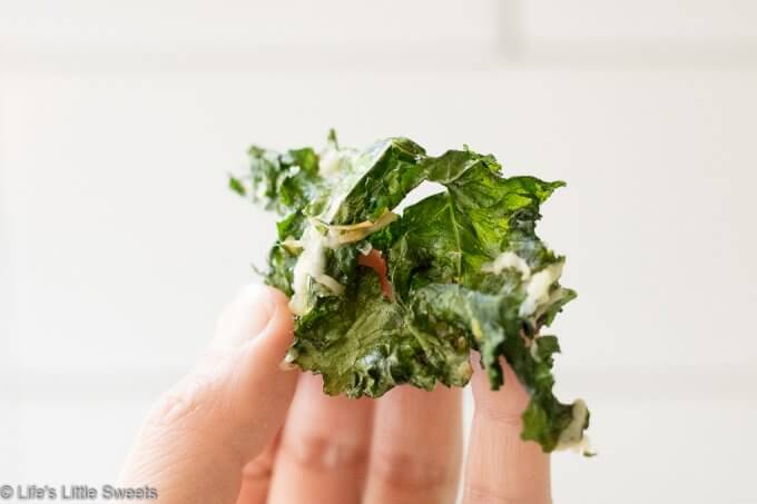 How to Make Kale Chips - hand holding kale chip
