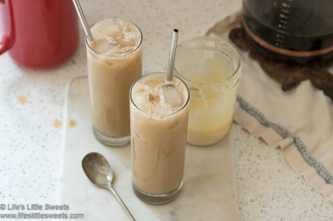 overhead view of sweet condensed milk coffee in two glasses with stainless steel straws