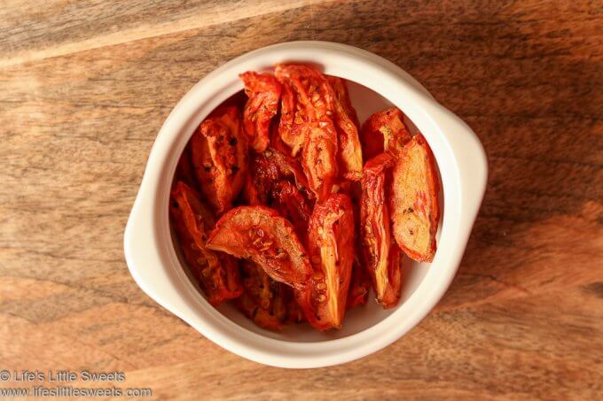 Air Fryer “Sun-Dried” Tomatoes are so easy to make in your Air Fryer! These tart, sweet, slightly acidic and flavorful dried tomatoes are delicious to snack on, in salads, sauces, pizzas, pastas – you name it! Add instant flavor with these delicious tomatoes that are also very good for you! #tomatoes #airfryer #sundriedtomatoes #sides #topping #fruit #recipe www.lifeslittlesweets.com