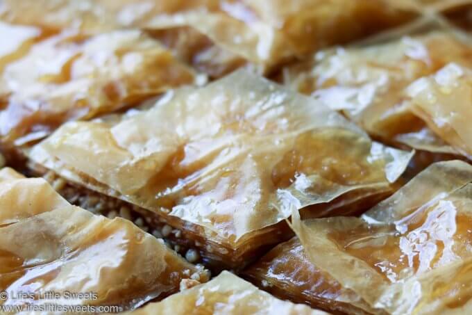 This Baklava is a classic baklava recipe with chopped walnuts, 40 sheets of layered Phyllo dough, olive oil (or butter) sugar, ground cinnamon and cloves, lemon zest, all infused with a honey, sugar, lemon syrup. Makes 30-40 pieces. #baklava #sweets #desserts #honey #nuts #walnuts #dessert #sweet #Phyllodough #recipe www.lifeslittlesweets.com