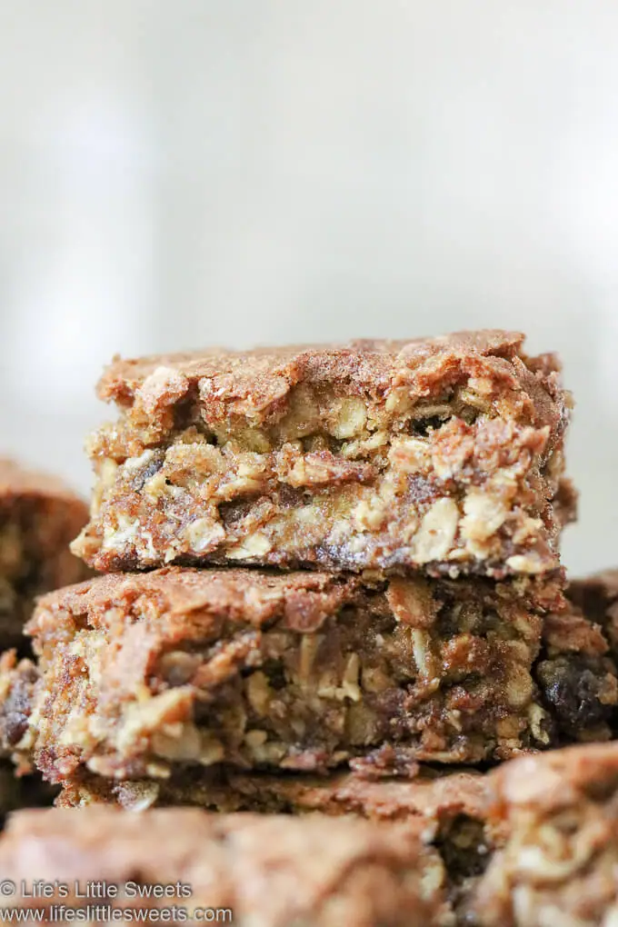 Oatmeal Raisin Cookie Bars stacked on a plate in a white kitchen