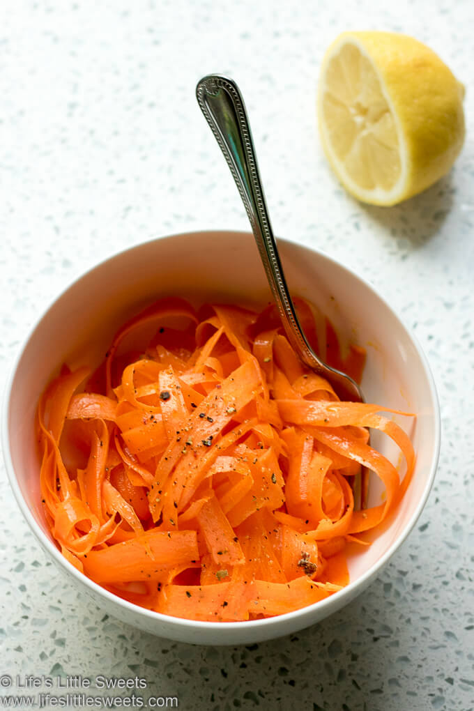 Carrot Ribbon Salad with a lemon on a white kitchen counter
