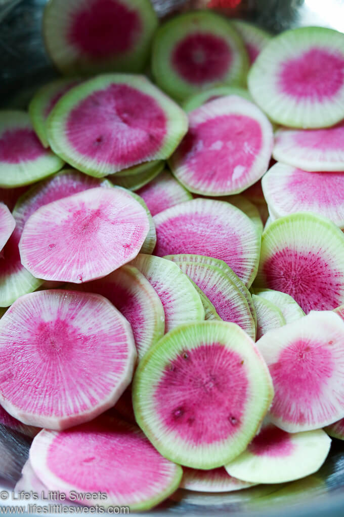 Watermelon Radish slices in a metal mixing bowl