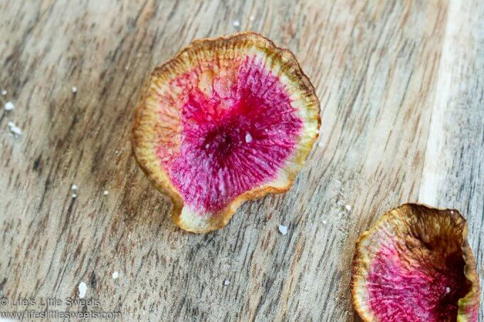 Air Fryer Watermelon Radish Chip with flakey salt on a cutting board