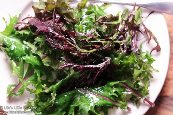 Massaged Baby Red Russian Kale Salad close up on a white plate