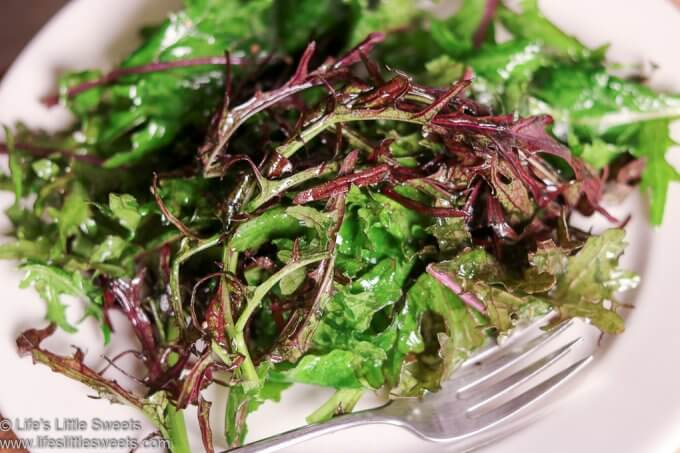 Massaged Baby Red Russian Kale Salad on a white plate