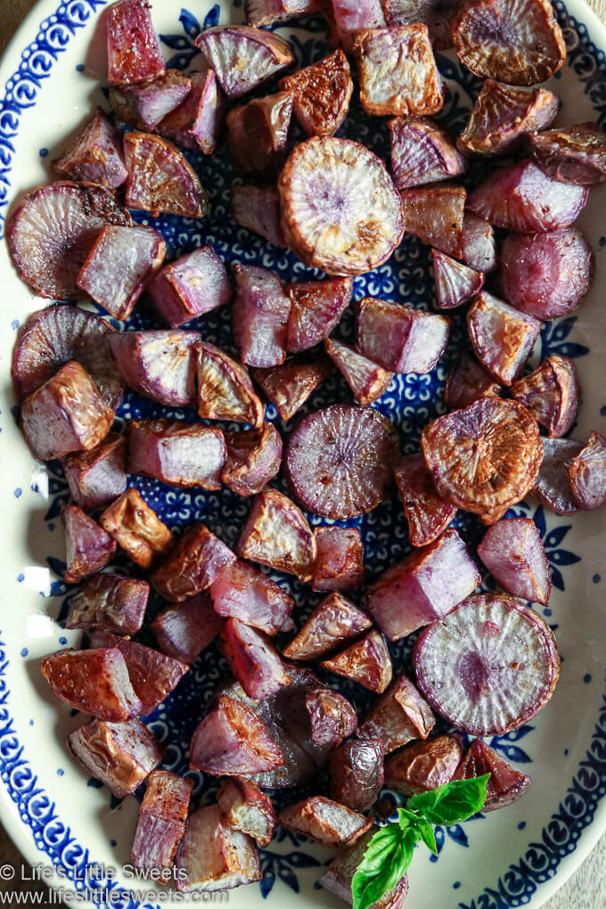Roasted Radishes on a serving dish with a basil sprig