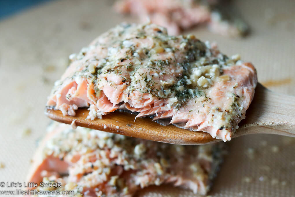 Dill Dijon Garlic Baked Salmon lifted out of the pan