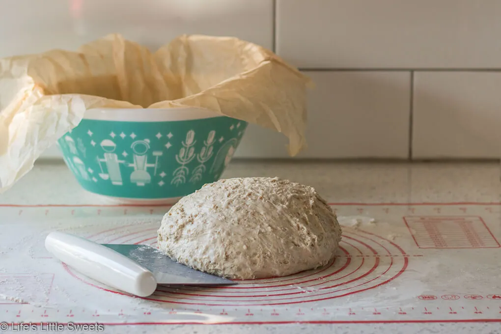 No-knead Oatmeal Bread dough on a pastry mat on the kitchen counter