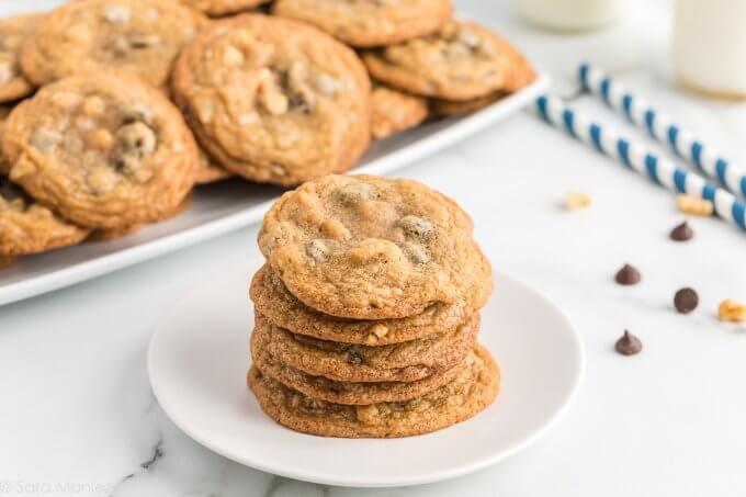 a stack of Chocolate Chip Cookies on a white plate with a marble background