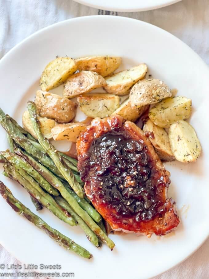 Pork chop dinner with roasted green beans and roasted potatoes overhead view