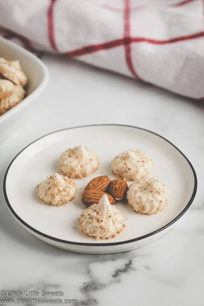 meringue cookies on a plate with almonds