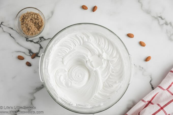 whipped egg whites in a clear glass bowl