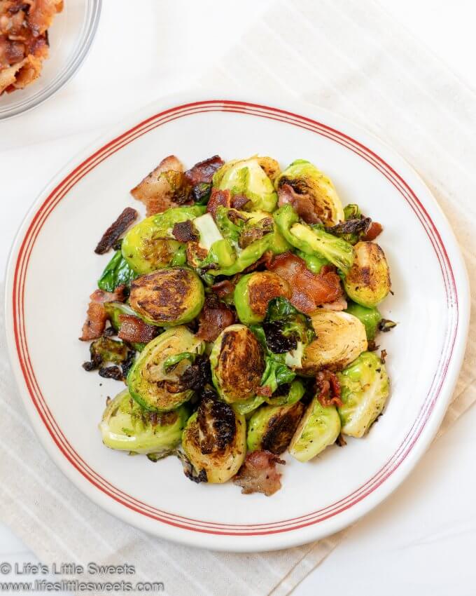 Pan-Fried Bacon Brussels Sprouts on a white plate with red stripes and white background