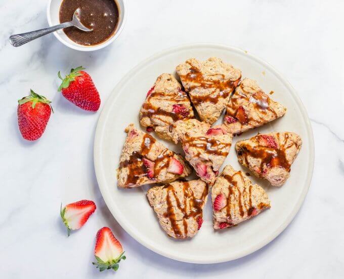 Vegan Soft Strawberry Scones on a white plate in a white kitchen with strawberries 