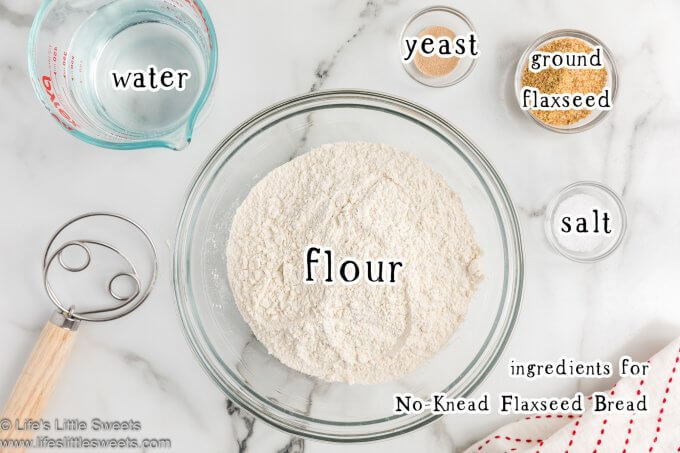 overhead photo of ingredients diagram for no-knead flaxseed bread recipe on a marble top