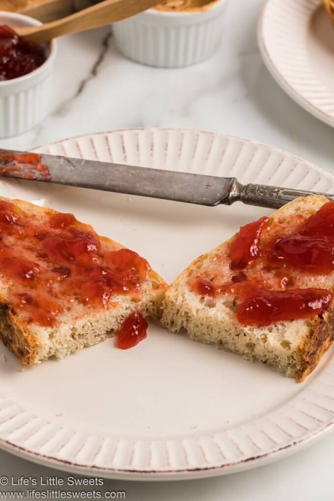 No-Knead Flaxseed Bread with milk sliced on a white marble countertop with red jam
