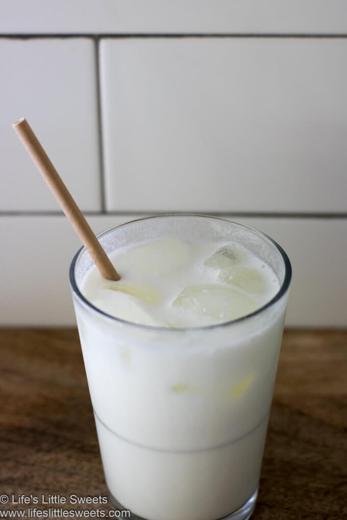 Milk in a glass with a brown paper straw