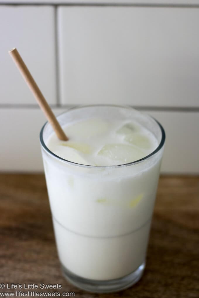 Milk in a glass with a paper straw