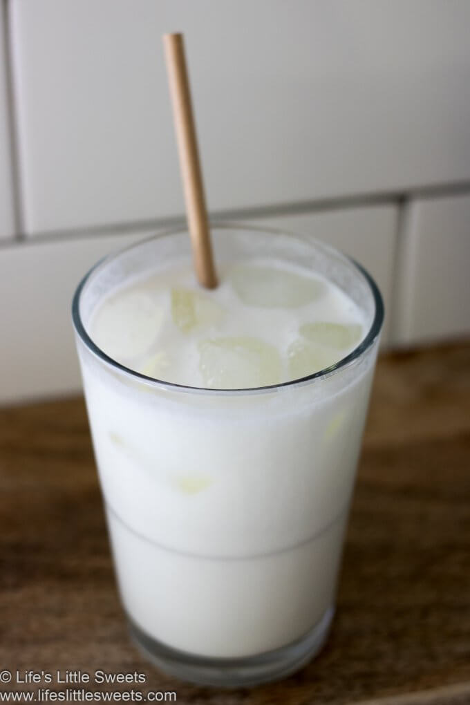 Milk in a glass with a paper straw