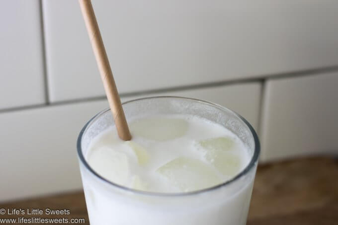 Milk in a glass with a paper straw