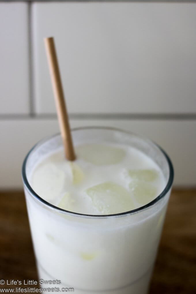 Milk in a glass with a paper straw