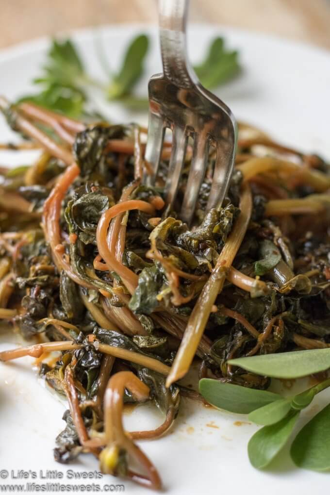 Sautéed Purslane with fork on a white plate