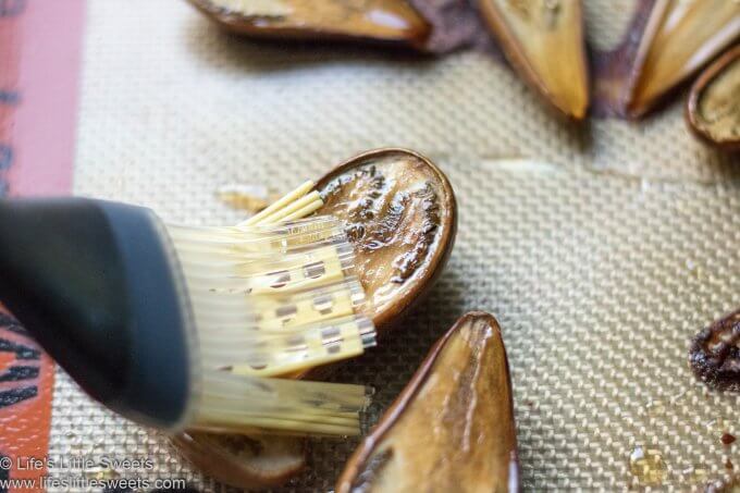 fairytale eggplant being brushed with olive oil
