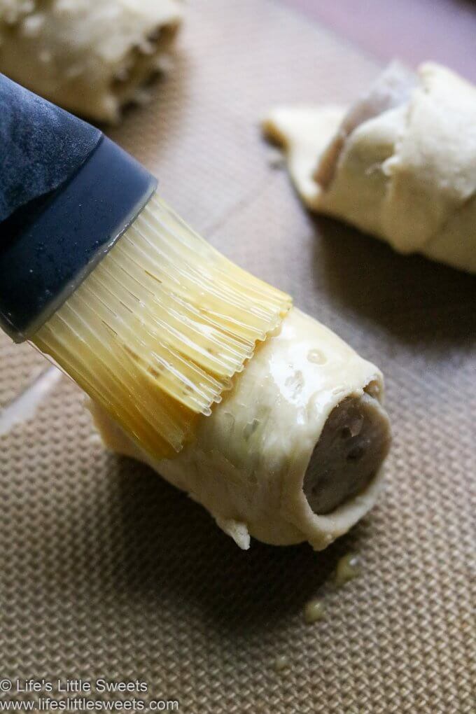 a silicone pastry brush, brushing an egg wash on a pastry