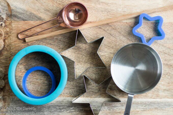cookie cutters, a chopstick a tablespoon measure and a cup measure