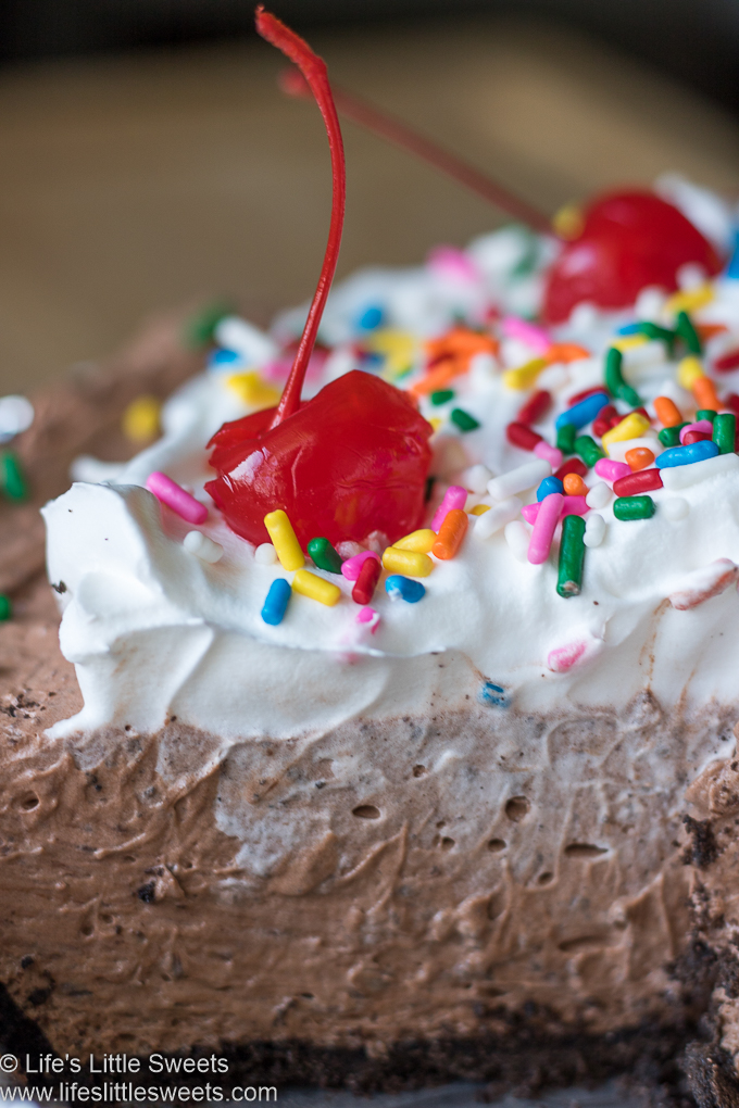 up close view of cherries, sprinkles Cool Whip and pudding pie sliced