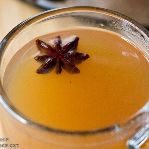 Hot Mulled Cider (Wassail) in a clear mug with star anise
