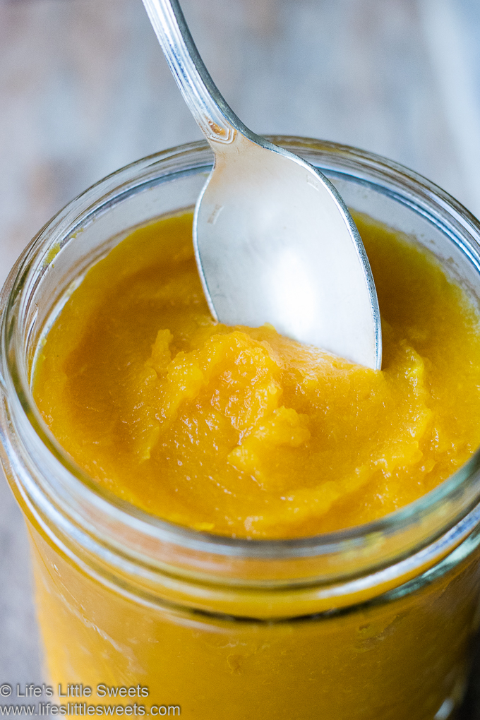 Pumpkin Purée in a glass jar with a spoon