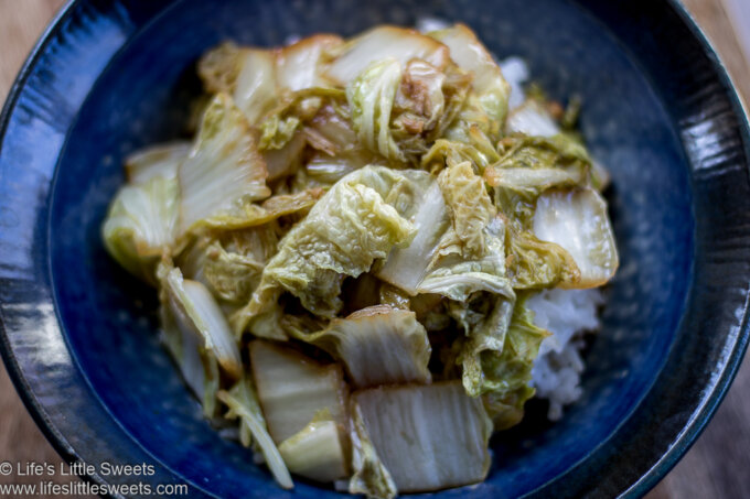 Stir-Fried Napa Cabbage in a blue bowl over steamed rice horizontal view