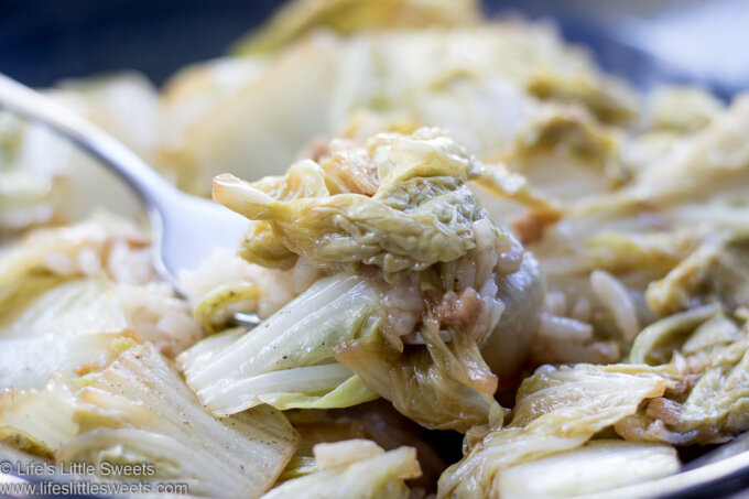 Stir-Fried Napa Cabbage in a blue bowl over steamed rice with a fork lifting some up