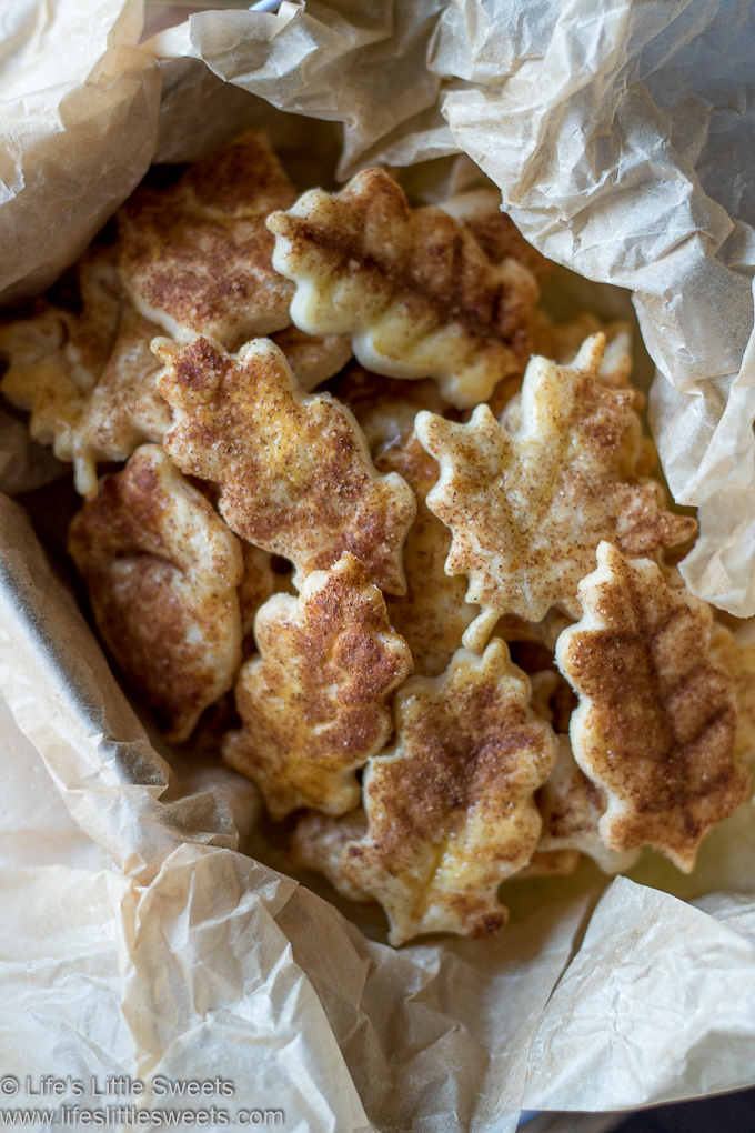 pie crust cookies in a tin with parchment paper