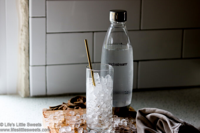 Sodastream bottle with glass of ice