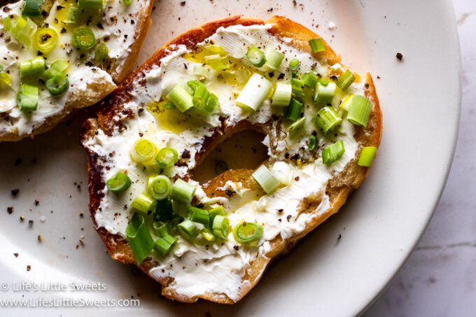 Bagel with Cream Cheese and Scallions on a white plate