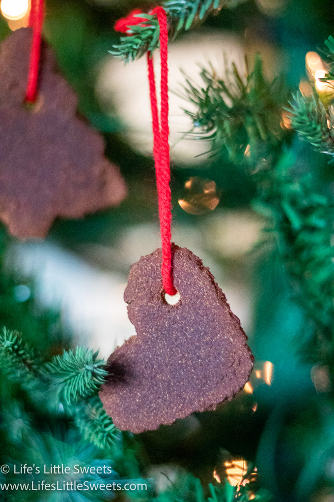 homemade Cinnamon Applesauce Ornaments hanging on a Christmas tree