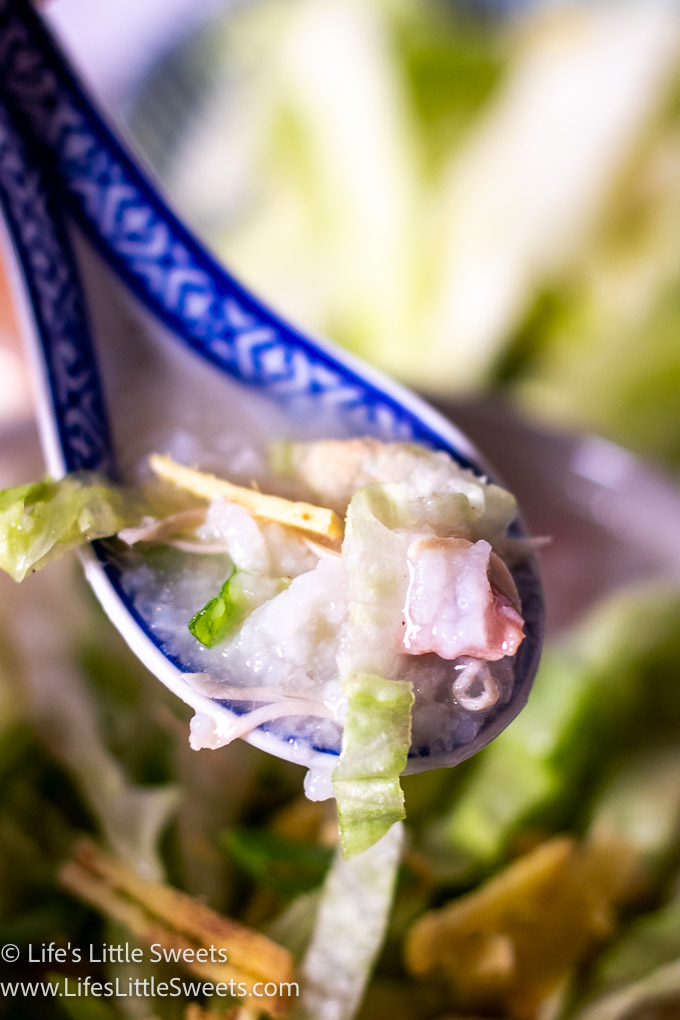 Congee Recipe with ginger, scallions and shredded iceberg lettuce in a spoon