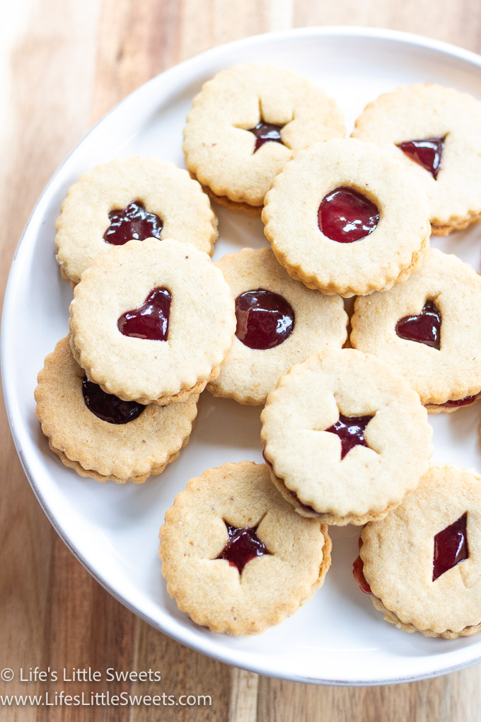 a plate of Linzer cookies with red jam