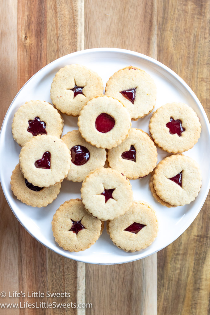 a plate of different shaped Linzer cookies