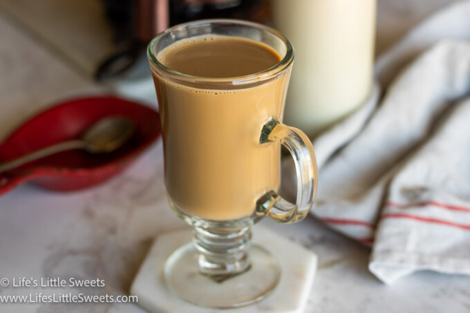 coffee with cream in a clear coffee mug in a white kitchen