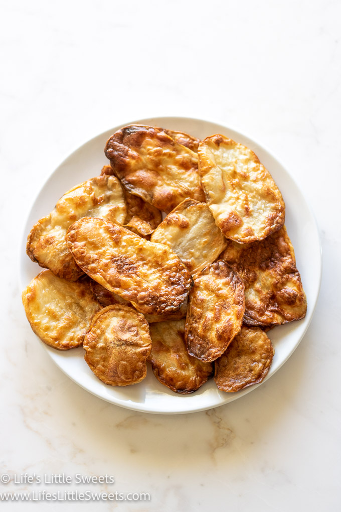Air Fryer Potato Chips on a white plate on a white marble countertop overhead view